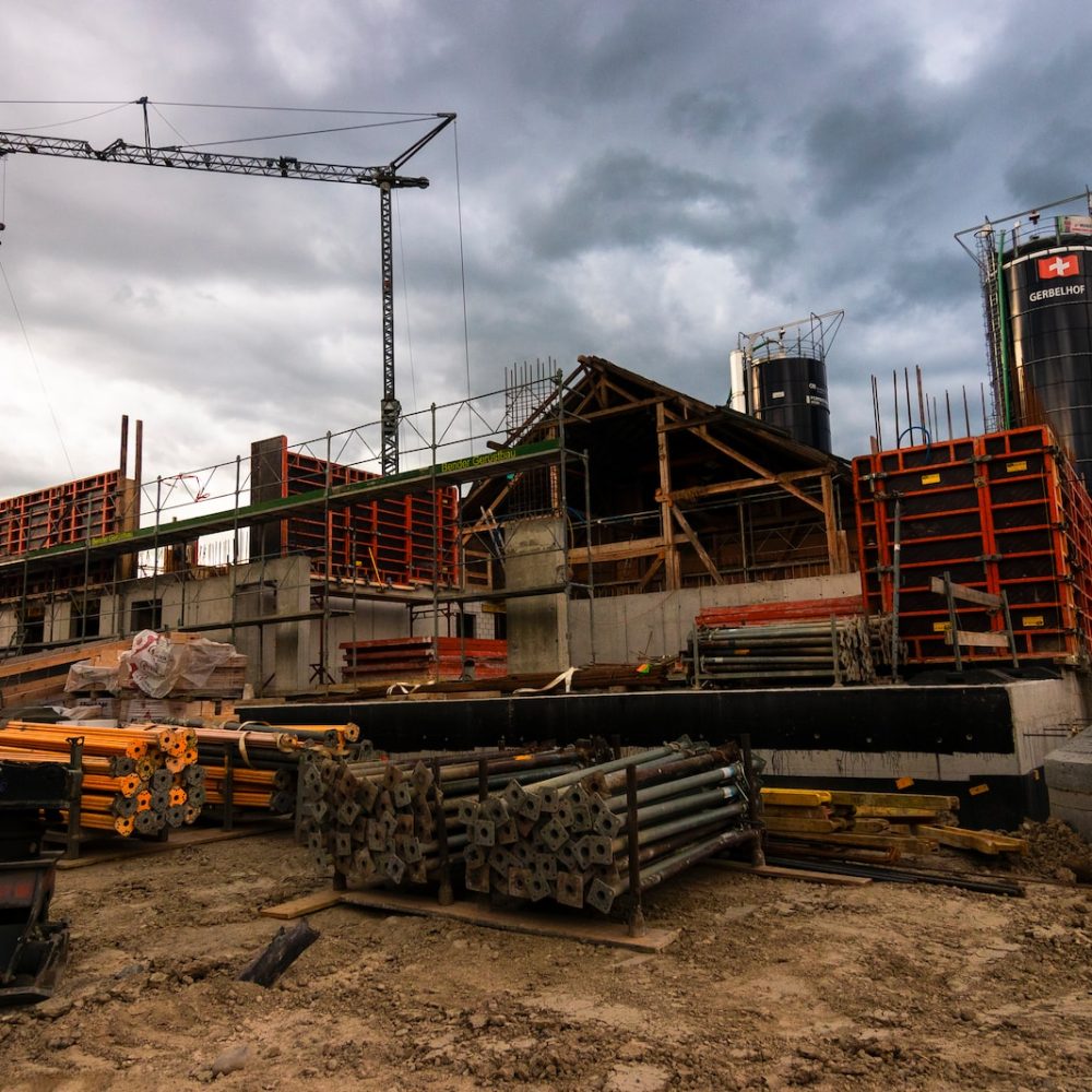 Photo by Jan Huber a construction site with a crane in the background